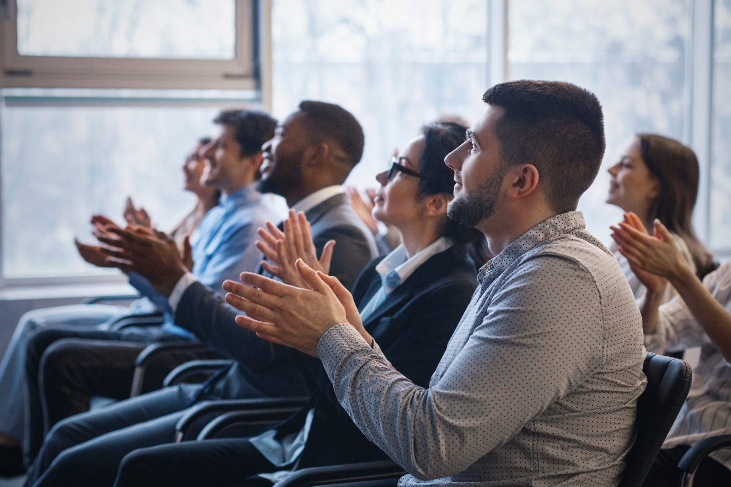 business conference. colleagues clapping hands to speaker
