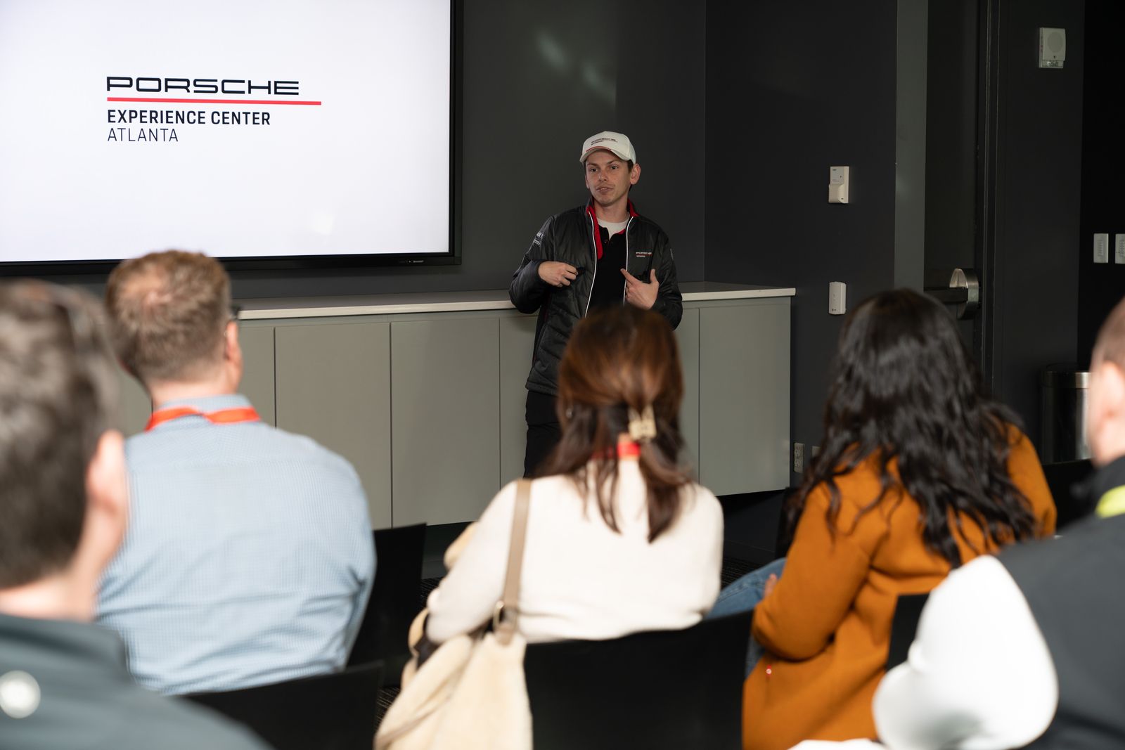 Guests listening to an instructor briefing at Porsche Experience Center Atlanta