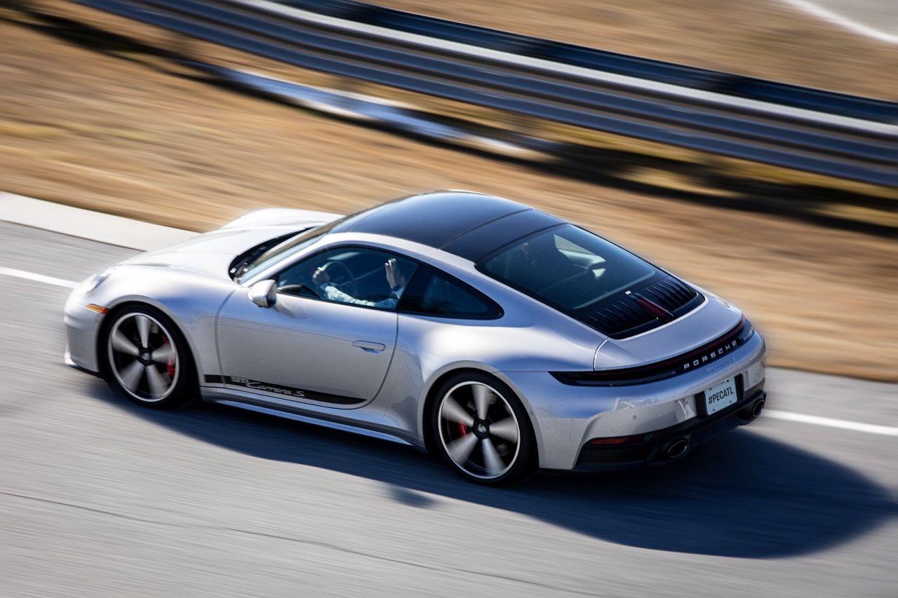 Silver sports car photographed at speed on the handling track